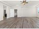 Large open room featuring wood flooring and recessed ceiling with a view to other rooms at 7931 Campers Village Ave, Las Vegas, NV 89178