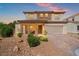 Charming two-story home featuring a brick-accented facade, covered porch, and a manicured front yard at 7931 Campers Village Ave, Las Vegas, NV 89178