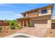 Beautiful two-story home with brick accents, desert landscaping, and a spacious two-car garage at 7931 Campers Village Ave, Las Vegas, NV 89178
