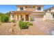 Charming two-story home with brick accents, desert landscaping, and a spacious two-car garage at 7931 Campers Village Ave, Las Vegas, NV 89178