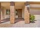 Inviting front porch with brick columns and a charming doorway at 7931 Campers Village Ave, Las Vegas, NV 89178