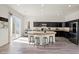 Spacious kitchen with dark cabinets, island seating, stainless appliances, and hardwood flooring at 7931 Campers Village Ave, Las Vegas, NV 89178