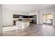 Bright open kitchen with a large island, stainless steel appliances, and backyard access at 7931 Campers Village Ave, Las Vegas, NV 89178