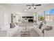 Open-concept living area flows into kitchen, featuring hardwood floors, modern lighting, and natural light at 7931 Campers Village Ave, Las Vegas, NV 89178