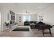 Large living room has a ceiling fan, hardwood floors, and a comfortable sectional sofa at 7931 Campers Village Ave, Las Vegas, NV 89178