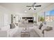 Open-concept living room with a ceiling fan and views into a spacious kitchen and backyard at 7931 Campers Village Ave, Las Vegas, NV 89178