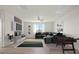 A contemporary living room with sleek furniture, a large TV, and a foosball table at 7931 Campers Village Ave, Las Vegas, NV 89178
