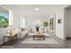 Bright living room features neutral decor, hardwood floors, and large windows for ample natural light at 7931 Campers Village Ave, Las Vegas, NV 89178
