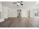 Spacious open floor plan with wood-look floors, connecting the living and kitchen areas with ease at 7931 Campers Village Ave, Las Vegas, NV 89178
