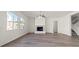 Spacious living room with a fireplace, large windows for natural light, and stylish flooring at 7931 Campers Village Ave, Las Vegas, NV 89178