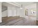 Open concept living space featuring wood-look floors and light, neutral walls at 7931 Campers Village Ave, Las Vegas, NV 89178