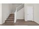 A simple staircase features wood treads, white risers, and a neutral color scheme at 7931 Campers Village Ave, Las Vegas, NV 89178