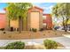 Exterior view of the condo building with manicured landscaping and covered parking at 8000 Badura Ave # 1058, Las Vegas, NV 89113