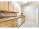 Well-lit kitchen showcasing ample counter space and white appliances at 8000 Badura Ave # 1058, Las Vegas, NV 89113