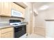 Kitchen with ample cabinet space, microwave, and a view of the living area at 8000 Badura Ave # 1058, Las Vegas, NV 89113