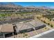 Aerial view of modern homes in a desert community with mountain views at 897 Woodburn Ln, Las Vegas, NV 89138
