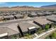 Aerial view of homes in a desert community with mountain views at 897 Woodburn Ln, Las Vegas, NV 89138