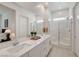 Bathroom showcasing dual sinks, a large mirror, and a glass-enclosed shower at 897 Woodburn Ln, Las Vegas, NV 89138