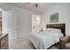 This bright bedroom boasts soft carpet, neutral walls, and an en suite bathroom at 897 Woodburn Ln, Las Vegas, NV 89138