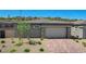 Charming single-story home with brick driveway and desert landscaping at 897 Woodburn Ln, Las Vegas, NV 89138