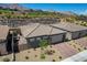 Charming single-story home featuring a desert landscape, brick driveway and stone accents at 897 Woodburn Ln, Las Vegas, NV 89138