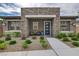 Charming single-story home with a stone facade, inviting entrance, and nicely landscaped front yard at 897 Woodburn Ln, Las Vegas, NV 89138