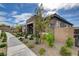 Well-kept house boasting stone accents, desert landscaping, and a paved pathway leading to the entrance at 897 Woodburn Ln, Las Vegas, NV 89138