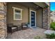 Close-up of front porch with two chairs and a blue front door featuring decorative glass panels at 897 Woodburn Ln, Las Vegas, NV 89138