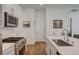 Spacious kitchen featuring modern appliances, white cabinetry, and an island with a sink at 897 Woodburn Ln, Las Vegas, NV 89138