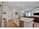 Open floor plan features kitchen with island, stainless appliances and quartz countertops at 897 Woodburn Ln, Las Vegas, NV 89138