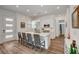 Bright kitchen with white cabinets, stainless steel appliances, and a large kitchen island with seating at 897 Woodburn Ln, Las Vegas, NV 89138