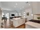 Open-concept floor plan with a modern kitchen island, connecting the kitchen with the living and dining spaces at 897 Woodburn Ln, Las Vegas, NV 89138
