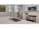 Modern kitchen featuring a stainless steel faucet, range, microwave and refrigerator with white cabinetry at 897 Woodburn Ln, Las Vegas, NV 89138