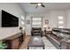 Comfortable living room features a ceiling fan, television, and leather seating at 897 Woodburn Ln, Las Vegas, NV 89138