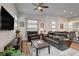 Stylish living room with a leather sofa, entertainment center, and an open layout leading to the kitchen at 897 Woodburn Ln, Las Vegas, NV 89138