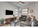 Comfortable living room features a ceiling fan, television, and leather seating at 897 Woodburn Ln, Las Vegas, NV 89138