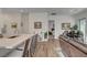 Open-concept living space featuring a spacious kitchen island, hardwood floors, and modern decor at 897 Woodburn Ln, Las Vegas, NV 89138