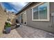 Cozy outdoor patio with brick pavers, comfortable seating, and view of retaining wall at 897 Woodburn Ln, Las Vegas, NV 89138