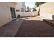 The backyard features a dirt area, brick borders, and a patio near the house at 9343 Leaping Deer Pl # 103, Las Vegas, NV 89178