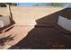 The backyard features a dirt area and brick borders at 9343 Leaping Deer Pl # 103, Las Vegas, NV 89178