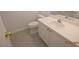 This bathroom features a white sink and vanity with gray tile flooring at 9343 Leaping Deer Pl # 103, Las Vegas, NV 89178