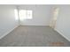 Large bright bedroom featuring modern carpeting and neutral paint at 9343 Leaping Deer Pl # 103, Las Vegas, NV 89178