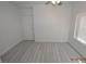 Bright bedroom features modern gray wood-look flooring and neutral paint at 9343 Leaping Deer Pl # 103, Las Vegas, NV 89178