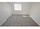 Bedroom with neutral carpeting, window and sliding closet doors at 9343 Leaping Deer Pl # 103, Las Vegas, NV 89178