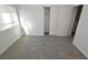 This bedroom features neutral carpeting, a window with blinds, and a closet for storage at 9343 Leaping Deer Pl # 103, Las Vegas, NV 89178