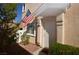 Charming front entrance adorned with American flag, manicured shrubs, and a cozy outdoor setting at 9343 Leaping Deer Pl # 103, Las Vegas, NV 89178