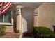 Inviting front door with American flag and updated lighting fixture at 9343 Leaping Deer Pl # 103, Las Vegas, NV 89178