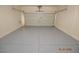 This garage features painted floors and a white garage door at 9343 Leaping Deer Pl # 103, Las Vegas, NV 89178
