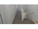 This hallway features gray carpeting and a staircase leading downstairs at 9343 Leaping Deer Pl # 103, Las Vegas, NV 89178