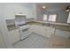 White cabinets, stone counter tops, gas range, and stainless steel dishwasher in kitchen at 9343 Leaping Deer Pl # 103, Las Vegas, NV 89178